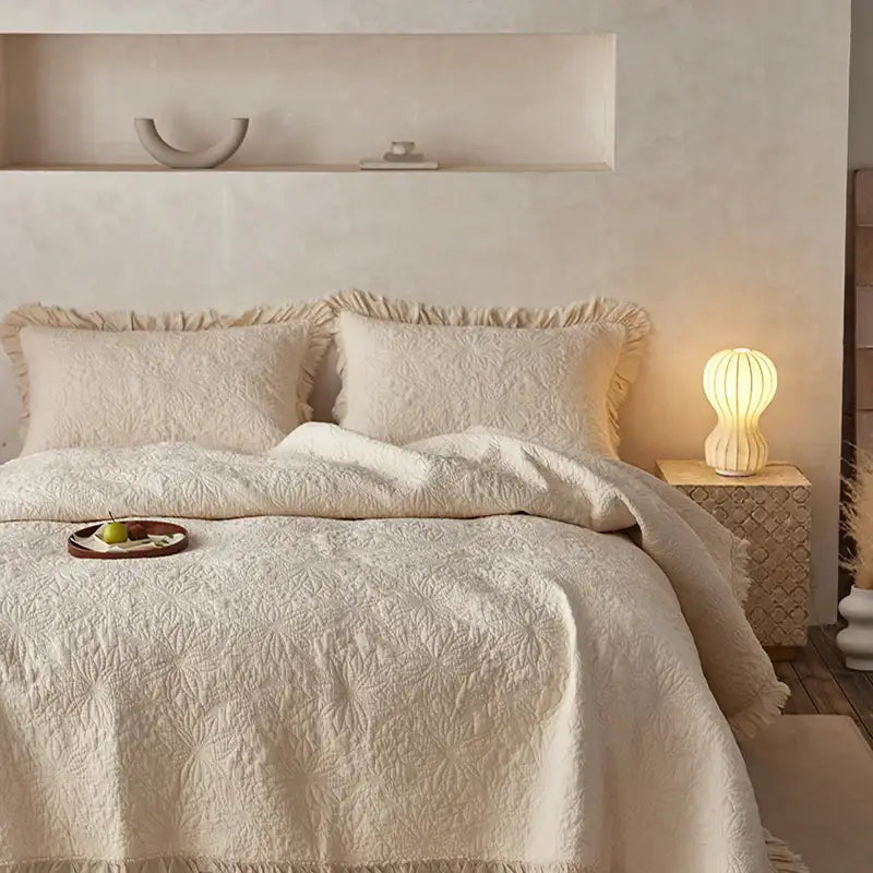 Cream-colored decorbites cotton quilted bedspread set with textured leaf pattern and soft frayed edges for bedroom decor