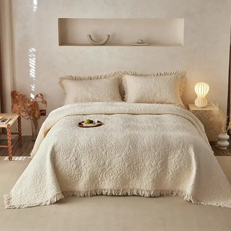 Cream-colored decorbites cotton quilted bedspread set with textured leaf pattern and fringed edges for bedroom decor