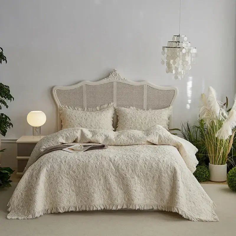 Cream-colored decorbites cotton quilted bedspread set with textured raised floral pattern and fringed edges for bedroom decor
