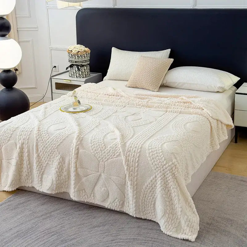 Cream-colored textured jacquard sofa cover blanket with plush knit featuring raised floral and geometric designs