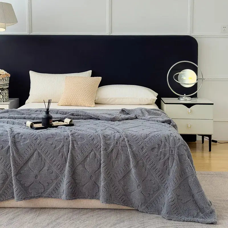 Gray plush throw blanket with textured diamond pattern used as a sofa cover blanket for living room decor