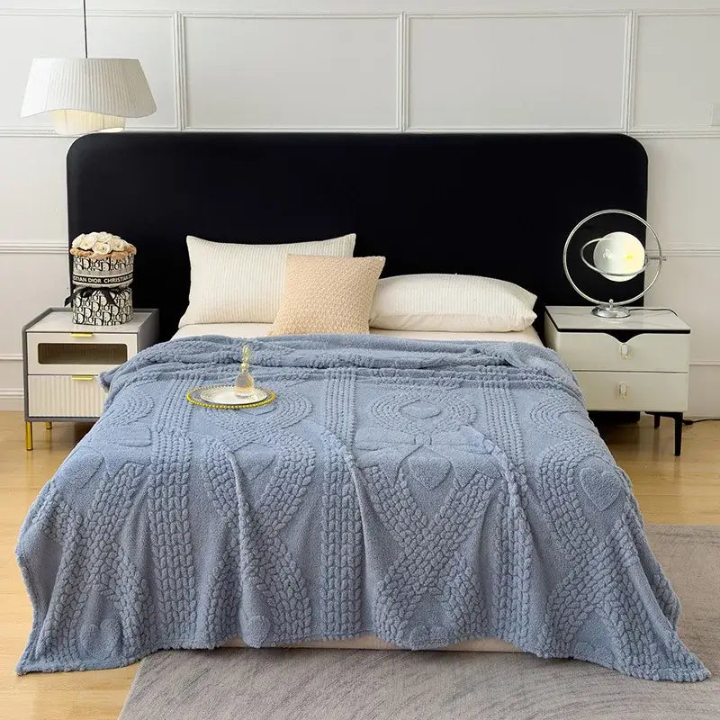 Soft blue knitted sofa cover blanket with heart and cable patterns for living room use