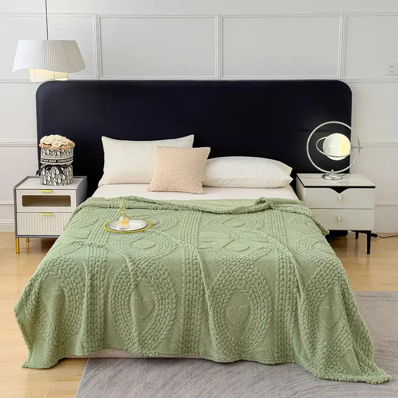 Soft mint green knitted sofa cover blanket with heart and swirl patterns, ideal as textured cream cover blanket