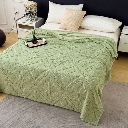 A soft mint-green textured sofa cover blanket with diamond-patterned jacquard design for living room use
