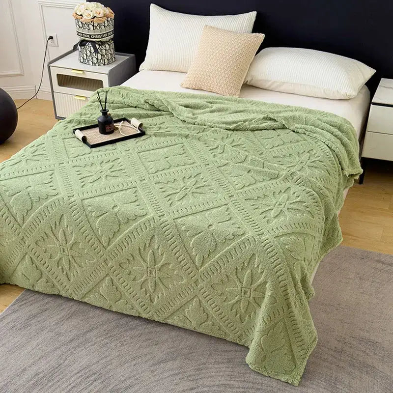 A soft mint-green textured sofa cover blanket with diamond-patterned jacquard design for living room use