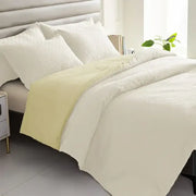 Cream-colored textured duvet cover with pale yellow border from a pillowcase quilt set by decorbites comforter