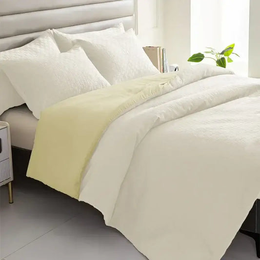 Cream-colored textured duvet cover with pale yellow border from a pillowcase quilt set by decorbites comforter