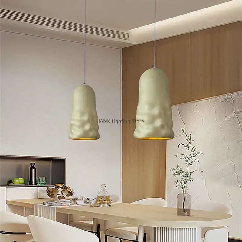 Two off-white textured ceramic pendant lamps with gold-finished interiors from decorbites creamy wind pendant series