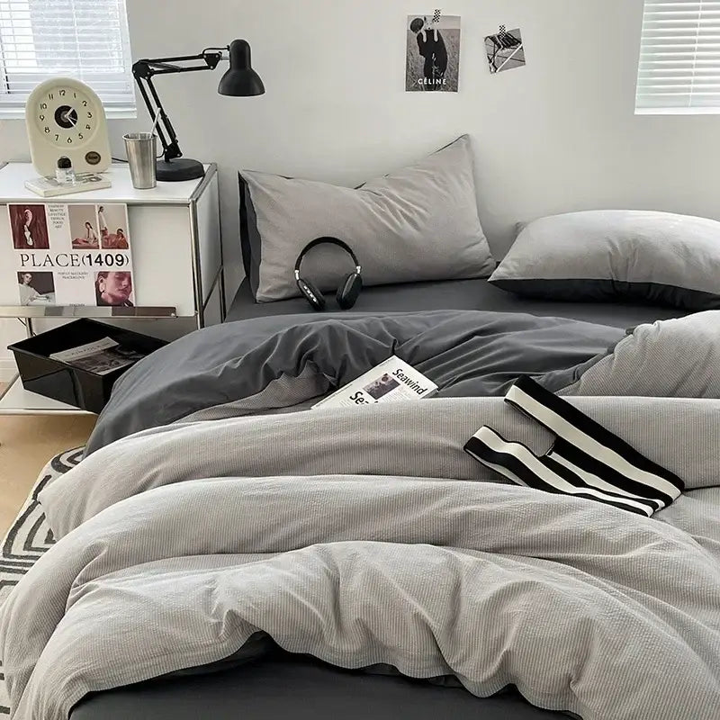 Textured dark gray and light gray bubble cotton quilt set with black and white striped accent pillow for bedroom use