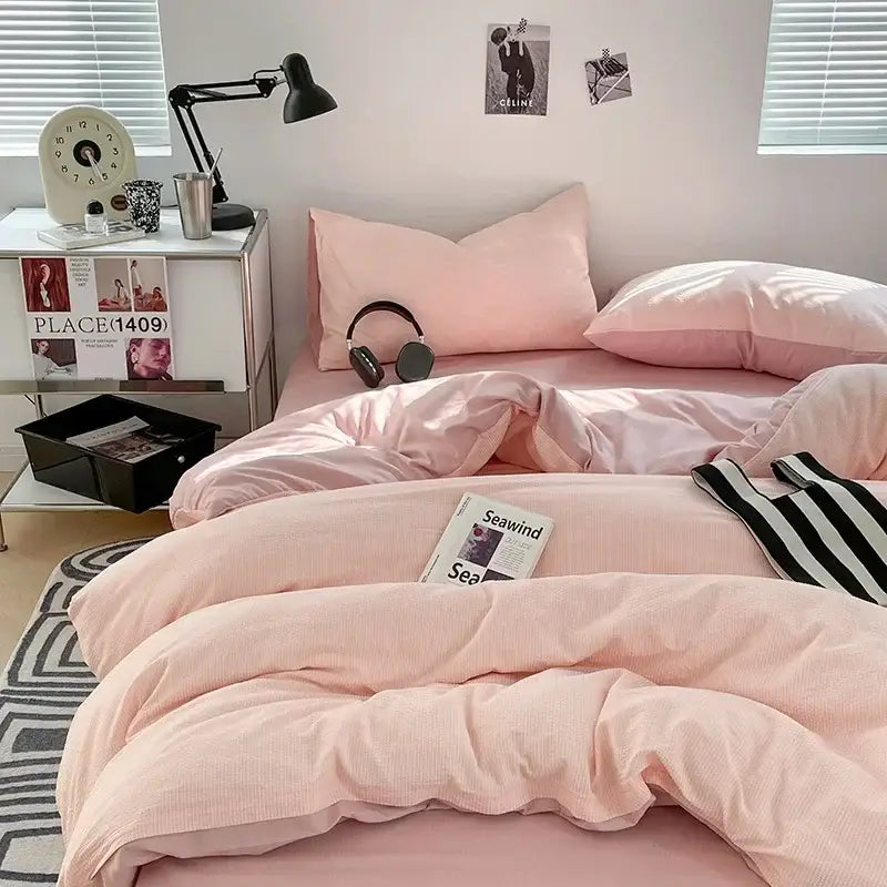 Pink corduroy duvet set with subtle ribbed texture paired with textured dark gray and light gray bubble cotton quilt sets