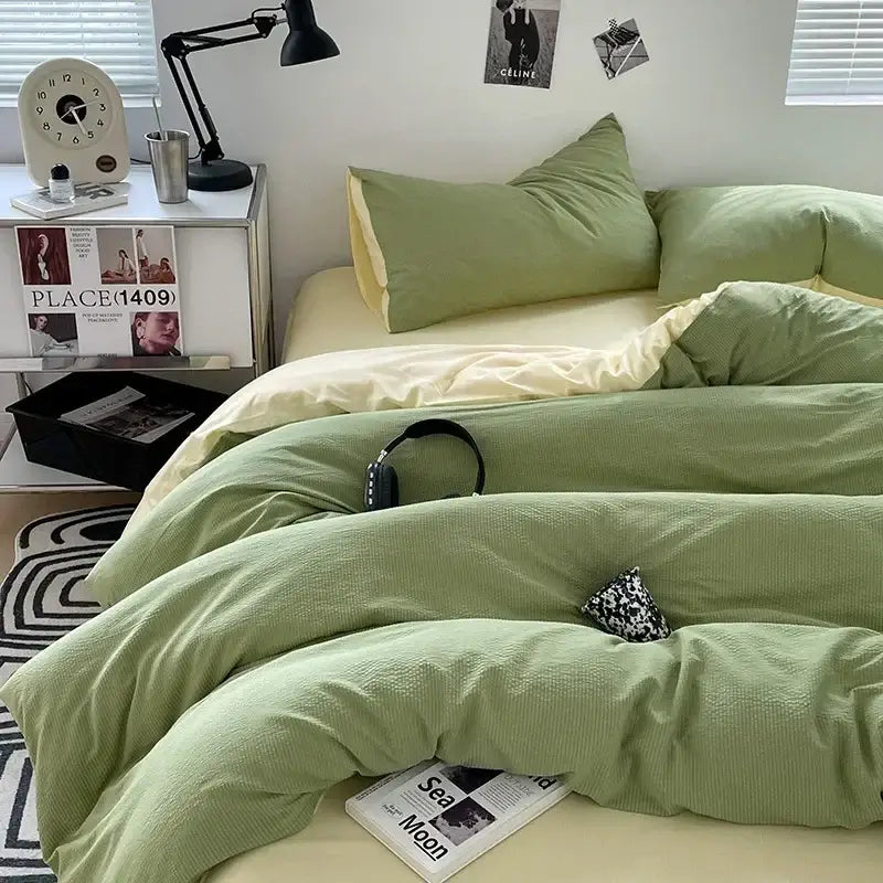 Soft sage green textured duvet cover set with subtle ribbed pattern and matching pillowcases in cotton quilt sets