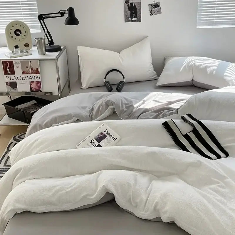White textured duvet cover with black striped knit top edge complements dark gray bubble cotton quilt sets for bedroom use