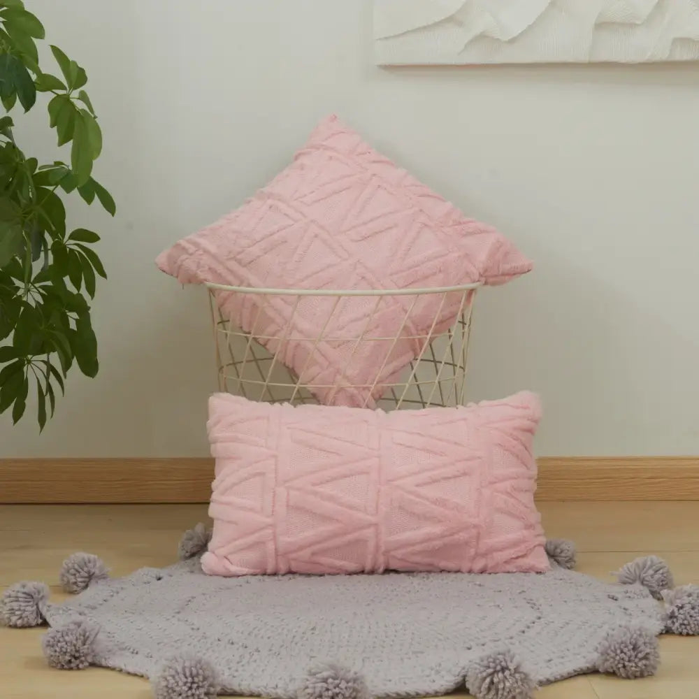 Soft pink cushion covers with textured earthy diamond embroidery living room design in a wire basket and on the floor
