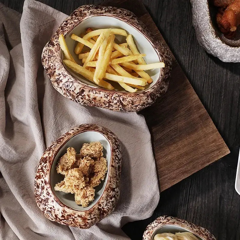 Brown speckled rock-shaped decorbites ceramic dessert bowl holding golden french fries for dining room use