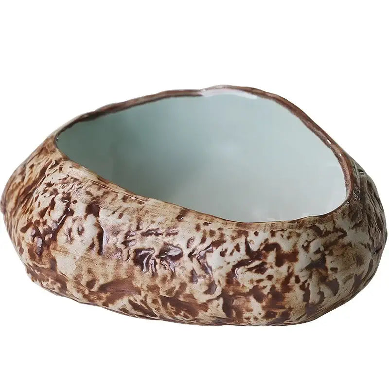 A rustic decorbites ceramic dessert plate with mottled brown exterior and smooth light blue interior for dessert sashimi ice