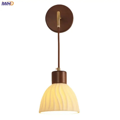 Warm-toned textured glass and brass wall light fixture with brown wooden base for dining room lighting