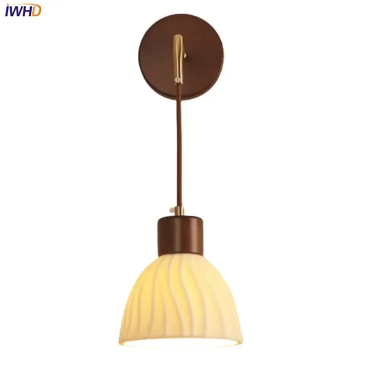 Warm-toned textured glass and brass wall light fixture with brown wooden base for dining room lighting