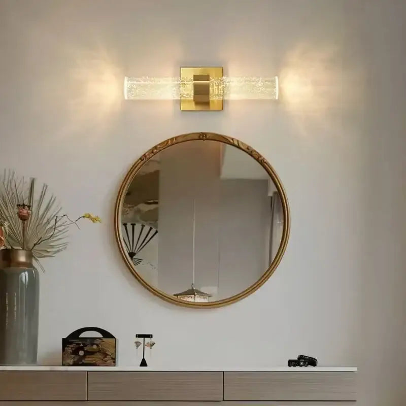 Gold wall sconce featuring a textured glass circular mirror with a decorative gold frame for warm bedroom decorbites wall sconce decor