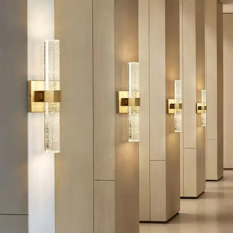 Gold wall sconce with textured translucent glass cylinder diffusing warm light for bedroom decorbites wall sconce