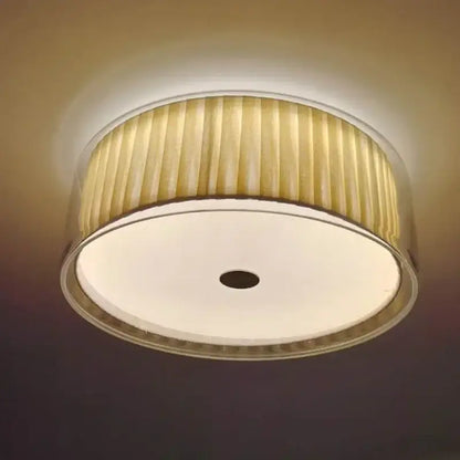 A warm-toned ceiling light with a pleated beige fabric shade and metallic rim for bedroom use ceiling lamp
