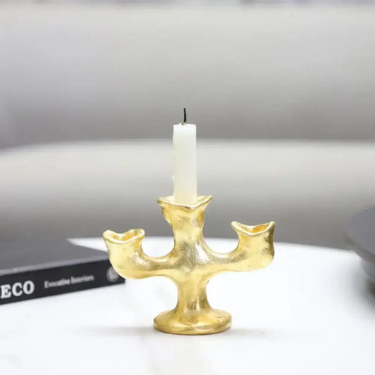 Gold resin candle holder with textured surface and white pillar candle decorbites gold resin dining room centerpiece