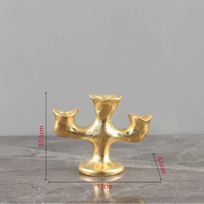 Golden textured candelabra candle holder with three arms on a sturdy base for decorbites gold resin candle decor