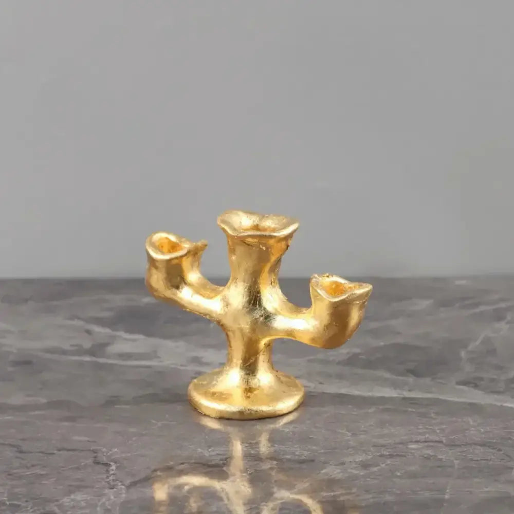 Gold resin candle holders trio featuring textured three-arm design in sculpted organic decorbites gold resin centerpiece