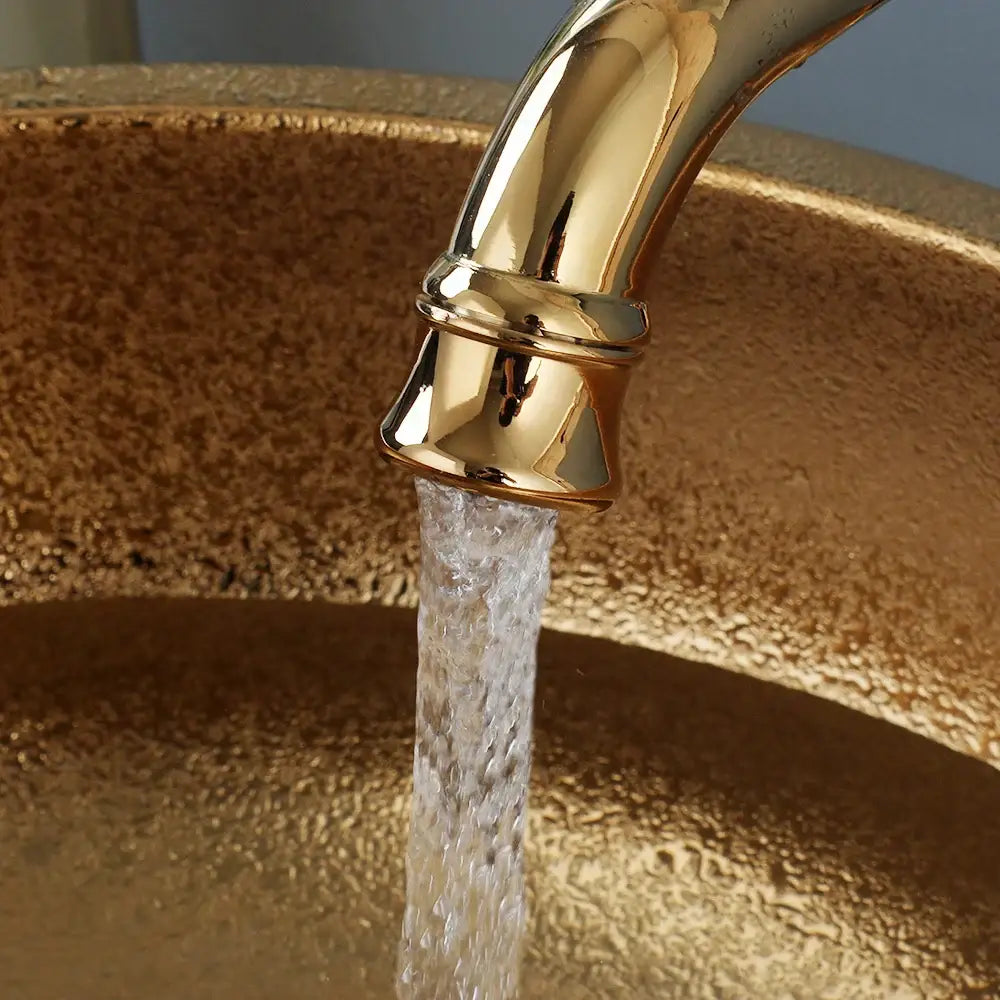 Gold-toned faucet with polished finish and decorative rings in decorbites golden ceramic bathroom basin set