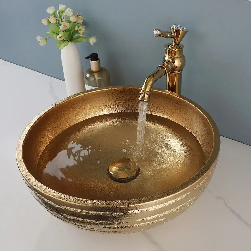 Textured golden ceramic bathroom basin set with ridged vessel sink and matching decorbites golden ceramic faucet