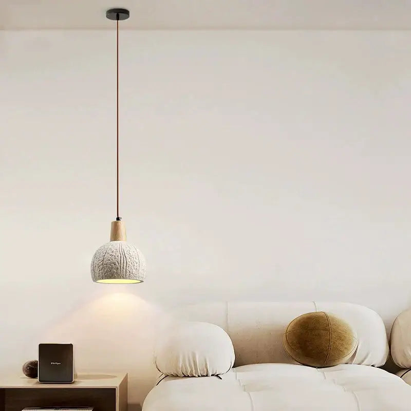 Minimalist pendant lamp with textured off-white ceramic shade and natural wood accent for dining room decorbites cement chandelier