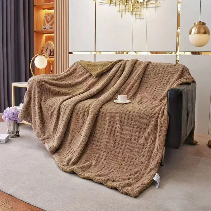A cozy beige knitted throw blanket with diamond texture and plush underside in coral fleece blanket style