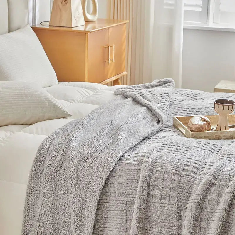 Textured gray coral fleece blanket with a soft fuzzy surface and woven pattern ideal as a cozy fleece blanket throw