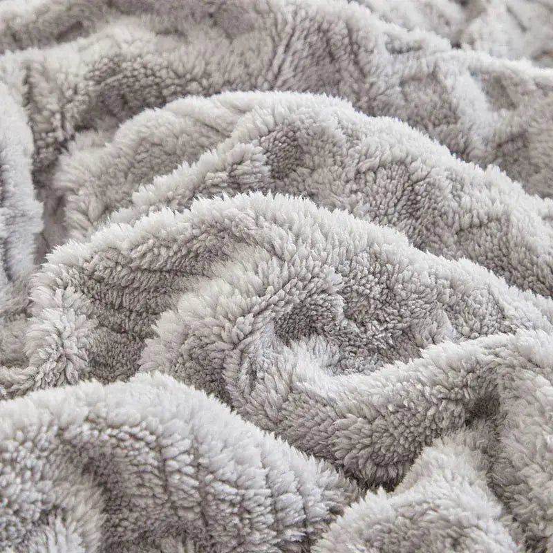 A plush soft gray coral fleece blanket with a cozy textured surface ideal for bedroom knit throw use
