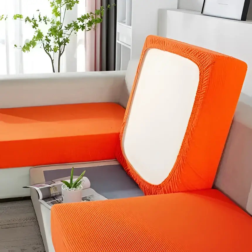 Orange textured fabric sofa cover with white rectangular panel on backrest for living room furniture protection