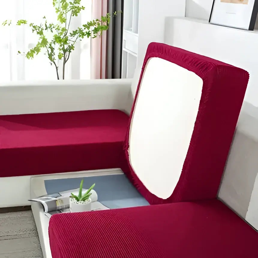 Red corduroy sofa cover with white panel on backrest designed as textured elastic living room furniture protector