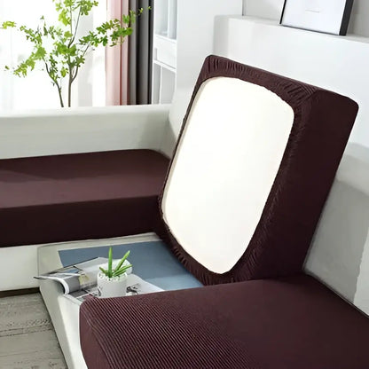 Brown stretchy fabric sofa cover with white rectangular panel on backrest for living room furniture protection