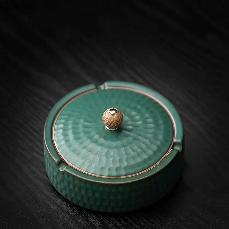 Teal green ceramic ashtray with hammered texture and wooden knob lid for living room smoking accessory