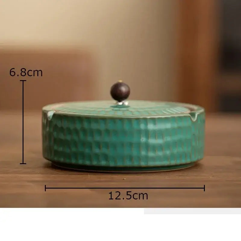 Textured green ceramic ashtray with a teal hammered pattern and dark brown wooden knob for office or living room decorbites ceramic ashtray