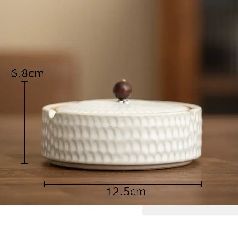 White ceramic ashtray with textured pebbled surface and dark brown wooden knob lid by decorbites ceramic ashtray