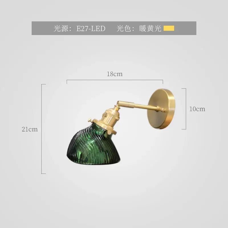 Vintage-style wall sconce with textured green glass nordic shade and brass-finished metal arms for bedroom lighting