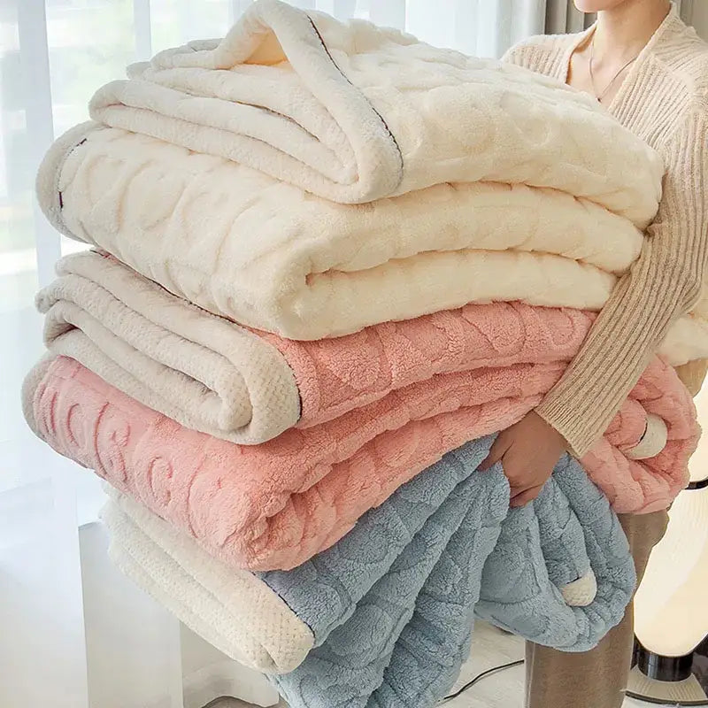 Stack of plush quilted fleece blankets in cream blush pink and blue showcasing decorbites cozy lamb wool blanket quality