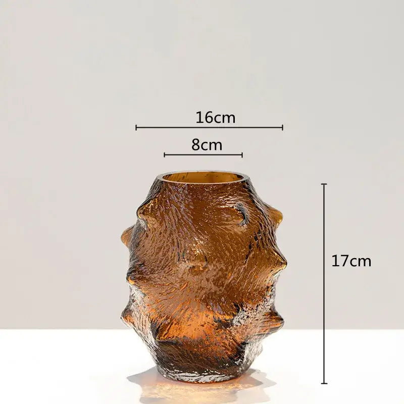 Textured amber glass vase with organic form and irregular ridges in a green sea cucumber glass vase set for decor