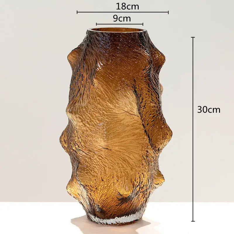 A tall amber sea cucumber glass vase with textured organic surface and irregular ridges for living room decor