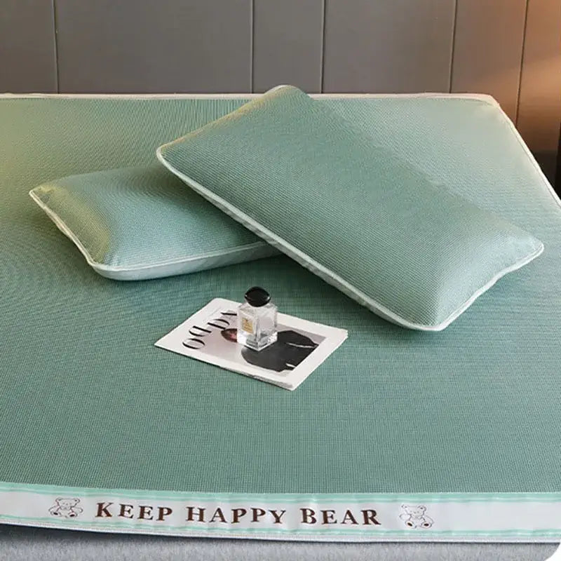 Mint green textured cooling bed mat with white trim and keep happy bear branding made of 1800d cooling fibres pillowcases set
