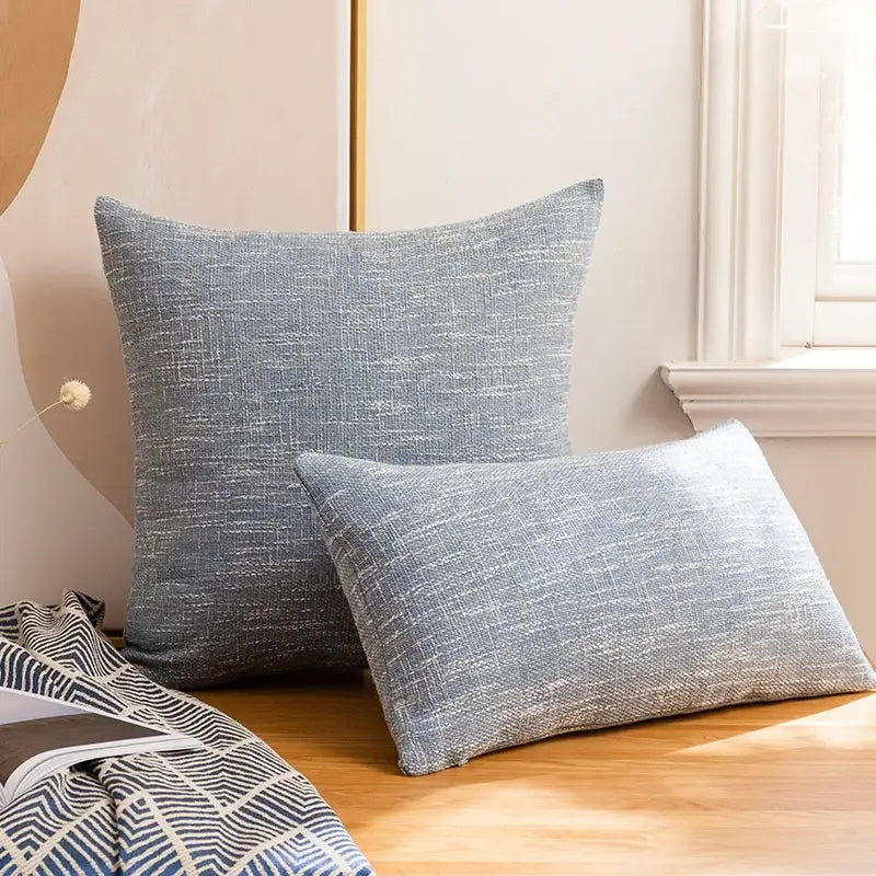 Gray textured linen cotton throw pillowcase with subtle woven pattern on wooden surface for living room decorbites decor