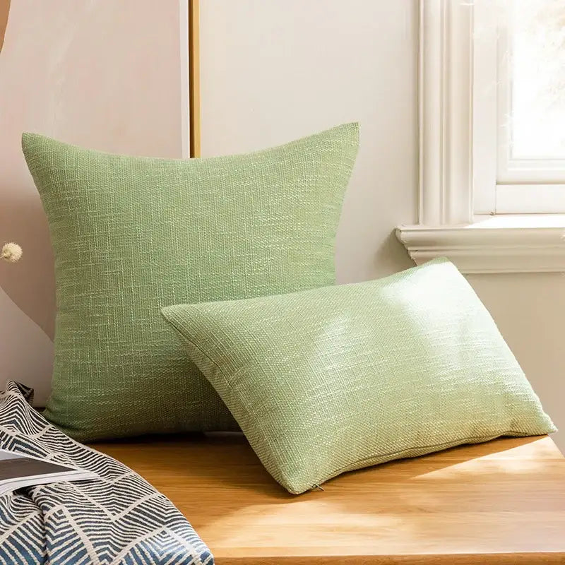 Two light green textured linen cotton throw pillows with subtle woven pattern for living room decorbites linen cotton