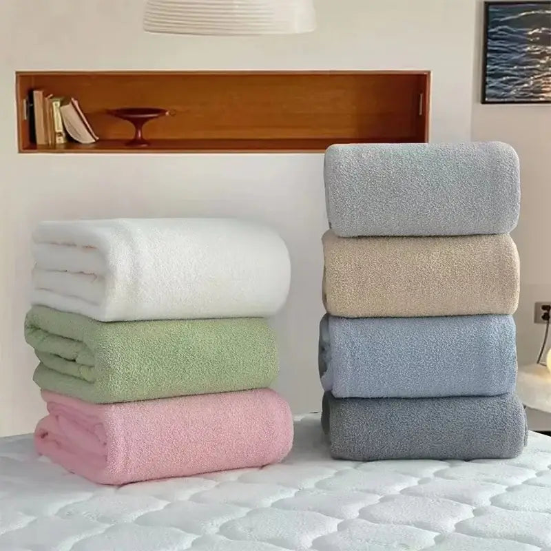 Stacked plush cotton bath towels in soft pastel hues with textured terry cloth finish complement decorbites cloud comforter