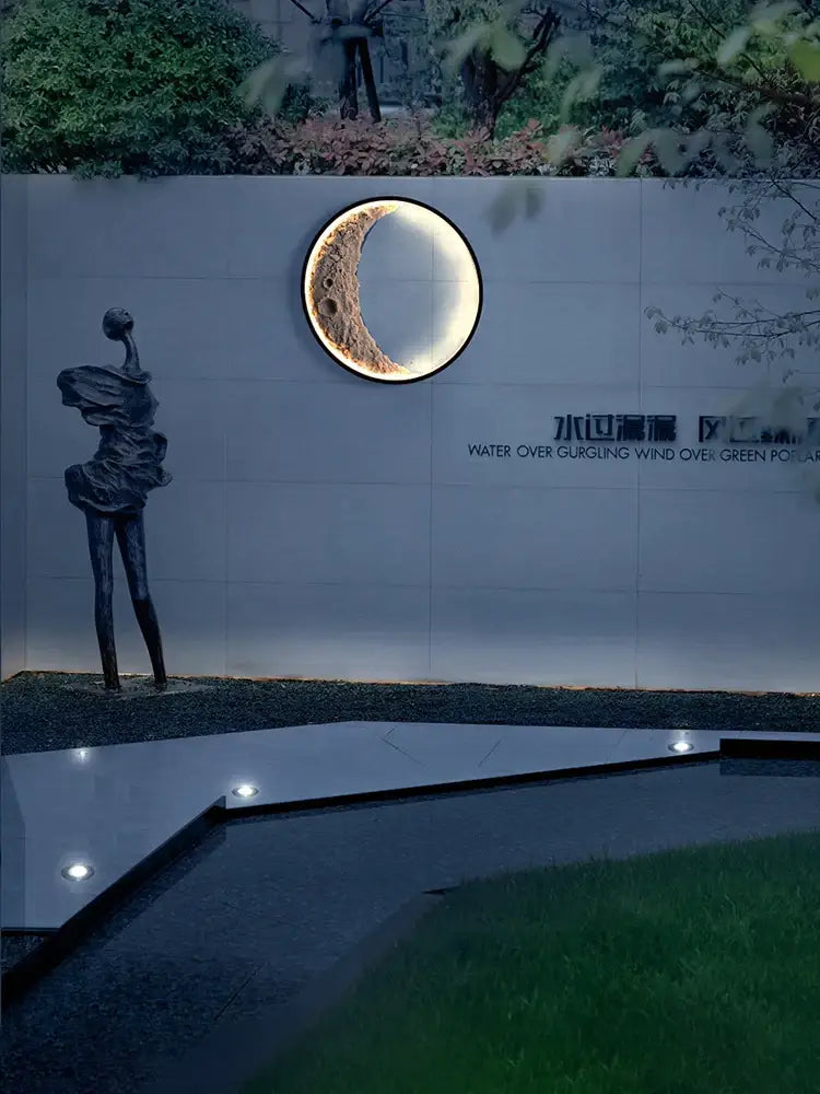 Circular wall lamp with textured golden crescent moon design by decorbites for garden terrace warm lighting