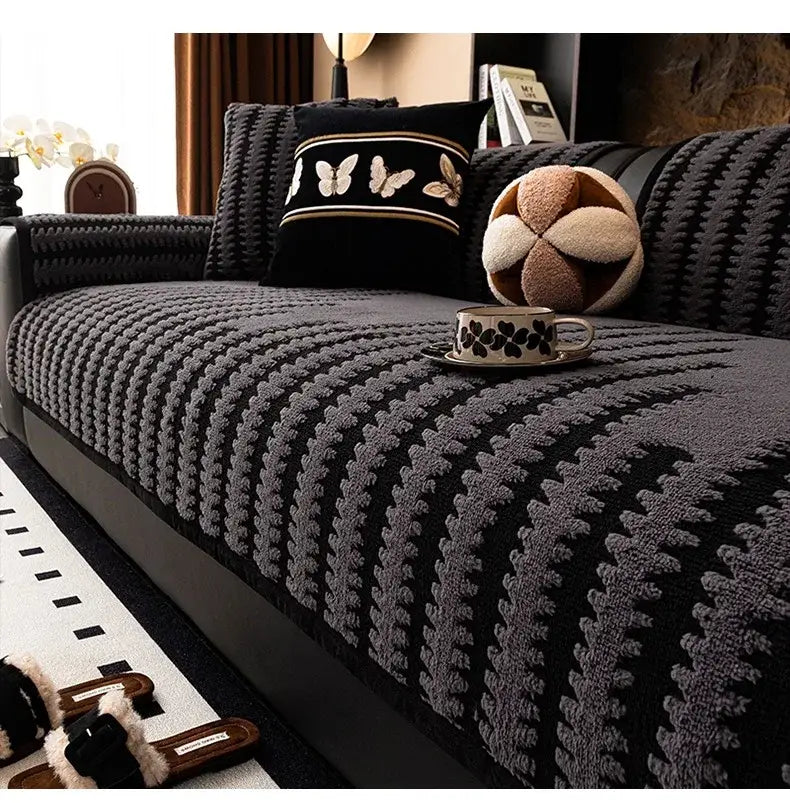 Textured olive and black striped knitted sofa cover with black and gray raised leaf-like tufts for living room use
