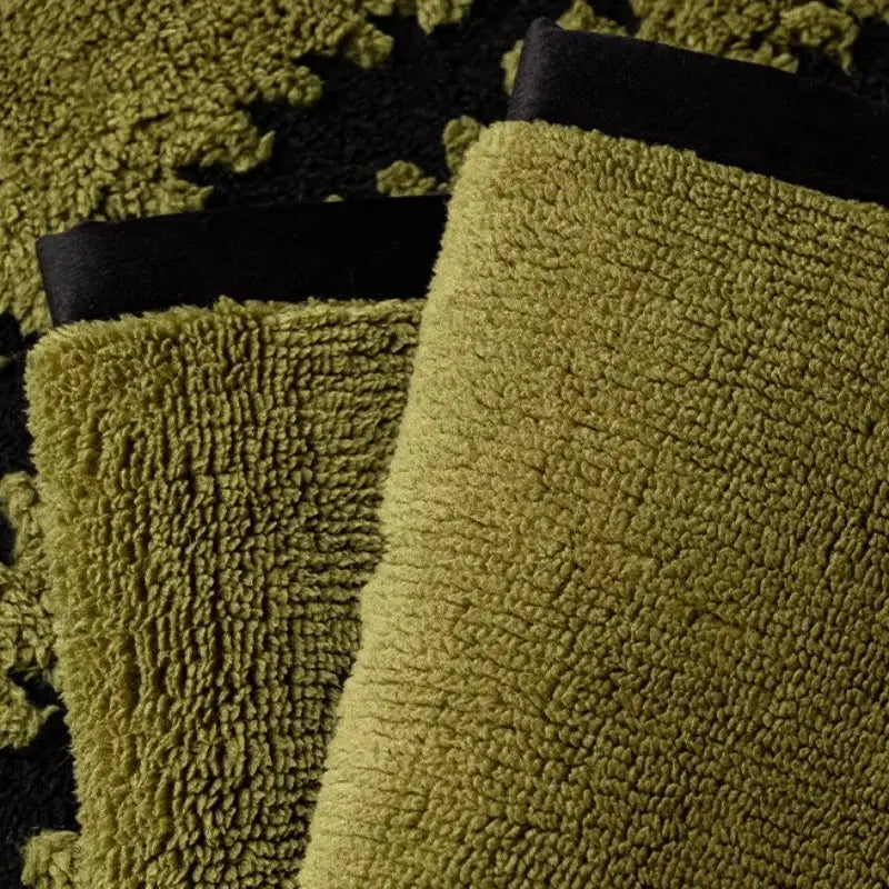 Olive green plush towel with soft textured surface and black fabric trim for textured olive and black sofa cover